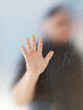 Silhouette of a man's body through frosted glassSilhouette