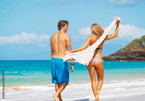 Photo: Attractive Couple Having fun on the Beach Attractive Couple Having fun on the Beach