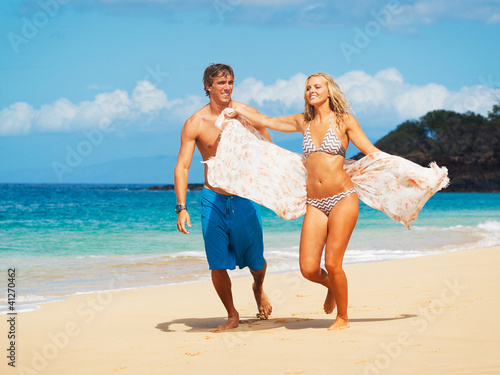 Photo: Attractive Couple Having fun on the Beach Attractive Couple Having fun on the Beach