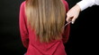 Hairdresser cutting very long hair