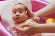 Adorable baby having bath