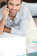 Man on bed telephoning