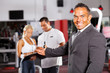 friendly gym manager welcome customer