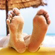 Photo: woman feet on the beach woman feet on the beach