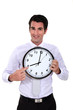 happy businessman pointing at clock
