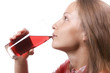 Young woman with glass of red drink, isolated Young woman with glass of red drink, isolated