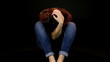 Girl feeling pain sitting on the ground