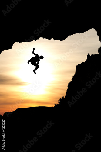 Photo: silhouette of man jumping of rock silhouette of man jumping of rock