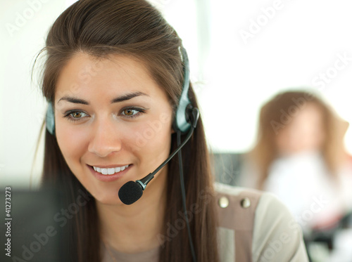 Photo: Female customer support operator with headset and smiling Female customer support operator with headset and smiling