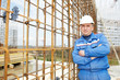 foreman at construction site with working drawings