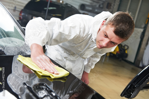 Photo: mechanic repairing and polishing car headlight mechanic repairing and polishing car headlight