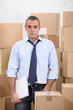 Man in storage depot surrounded by boxes