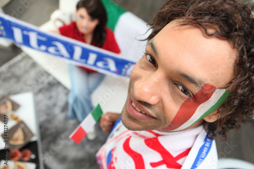 Photo: Two Italy fans watching match at home Two Italy fans watching match at home