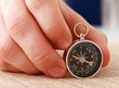Man's hand holding a compass. Man's hand holding a compass.