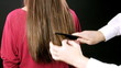 Hairdresser combing long wet hair