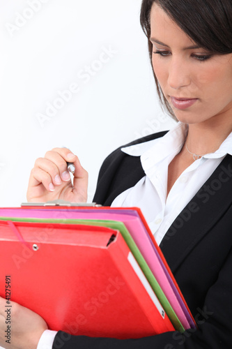 Photo: Young businesswoman holding folders Young businesswoman holding folders