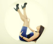 brunette in blue dress sitting in a circle