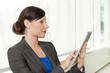 Photo: Business woman using a tablet computer Business woman using a tablet computer