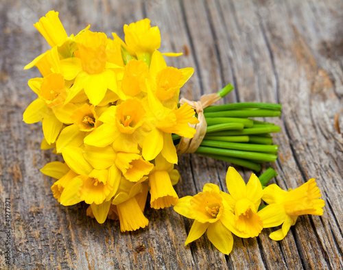 Photo: narcissus flowers on wooden background narcissus flowers on wooden background