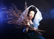 Photo: girl in medieval dress with bunch of sticks in smoke girl in medieval dress with bunch of sticks in smoke