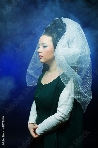 Photo: woman with long hair in historical medieval green dress woman with long hair in historical medieval green dress