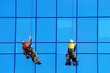 Two wahsers wash facade windows