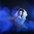 Photo: girl in medieval dress with bunch of sticks in smoke girl in medieval dress with bunch of sticks in smoke