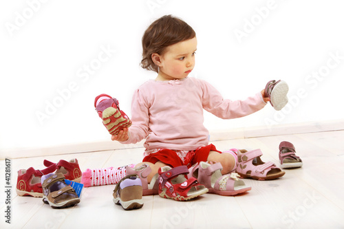 Photo: Kleinkind freut sich über ein Paar Schuhe Kleinkind freut sich über ein Paar Schuhe