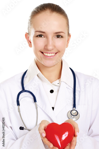 Photo: Female doctor standing with stethoscope and red heart symbol Female doctor standing with stethoscope and red heart symbol