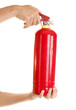 Hands are holding red fire extinguisher