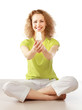 Woman with energy-saving bulb sitting cross-legged on floor.