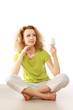 woman with energy-saving bulb sitting cross-legged on floor.