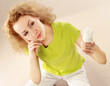 Happy young woman looking at energy saving bulb and thinking