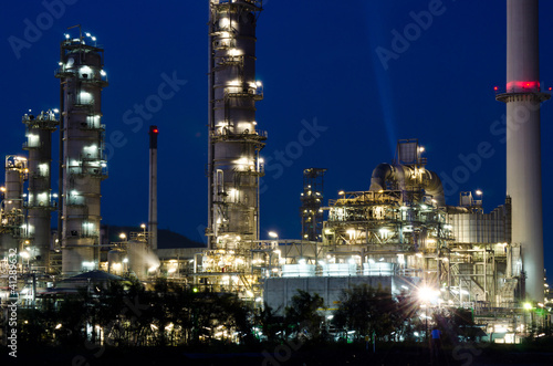 Photo: Petrochemical industry on sunset dark blue sky. Petrochemical industry on sunset dark blue sky.