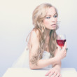 Beautiful blond woman with glass red wine