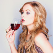 Beautiful blond woman with glass red wine
