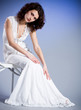 Young woman in retro bridal dress on blue background. Young woman in retro bridal dress on blue background.