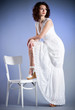 Young woman in retro bridal dress on blue background. Young woman in retro bridal dress on blue background.
