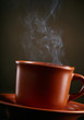 Cup of coffee with smoke over dark background Cup of coffee with smoke over dark background