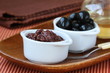 appetizer of olives, tapenade on a wooden board