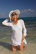 Photo: Woman with white hat on the beach Woman with white hat on the beach