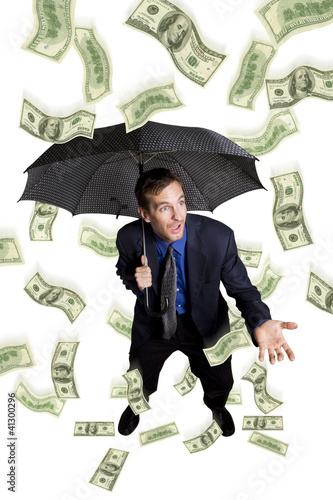 Foto: Raining money on a businessman with umbrella Raining money on a businessman with umbrella