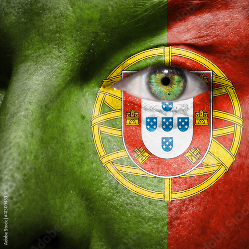 Illustration: Flag painted on face with green eye to show portugal support Flag painted on face with green eye to show portugal support