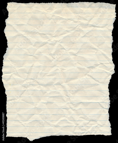 Photo: Old yellowing crumpled lined paper torn edges isolated on black. Old yellowing crumpled lined paper torn edges isolated on black.