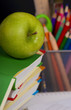 Green apple and pencil on pile of books Green apple and pencil on pile of books