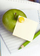 green apple and pencil on empty page of a notebook green apple and pencil on empty page of a notebook