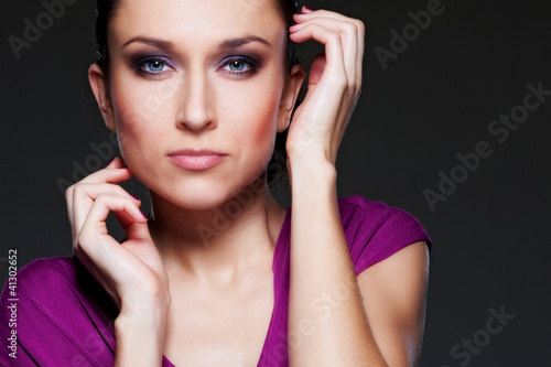 Photo: studio portrait of young woman over black studio portrait of young woman over black