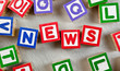 Wooden blocks forming the word NEWS in the center