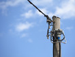 Foto: old wooden pole with cables for telephone and power services old wooden pole with cables for telephone and power services