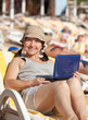 mature woman with laptop at beach mature woman with laptop at beach